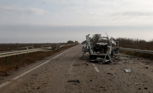 Destroyed car is seen on a highway to Kherson city