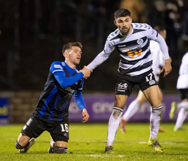 Josh Mullin is helped to his feet by now-teammate Nick McAllister