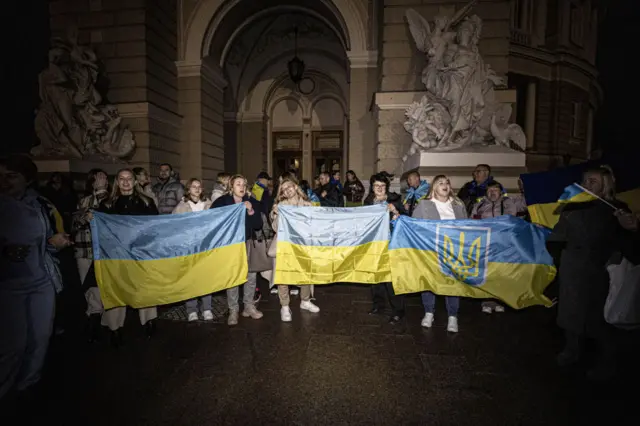 People who used to live in Kherson before the invasion and had to leave the city due to the war gather in front of the Odesa National Academic Theatre of Opera and Ballet in Odessa to celebrate the retreat of Russian forces from Kherson