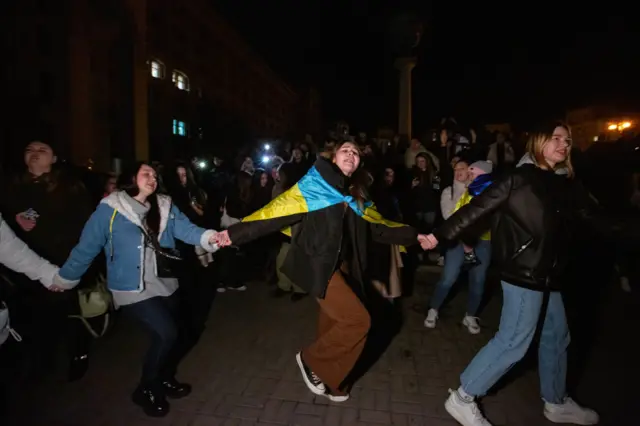 Ukrainians dance to celebrate the liberation of Kherson from Russian occupiers in central Kyiv on 11 November 2022