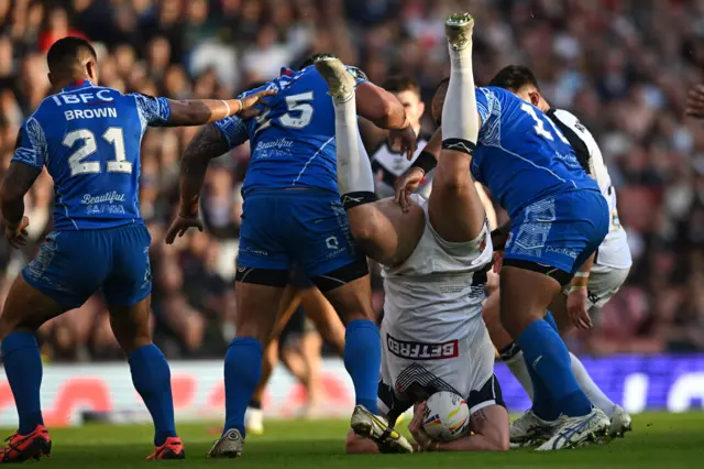 Tom Burgess is lifted up in the tackle