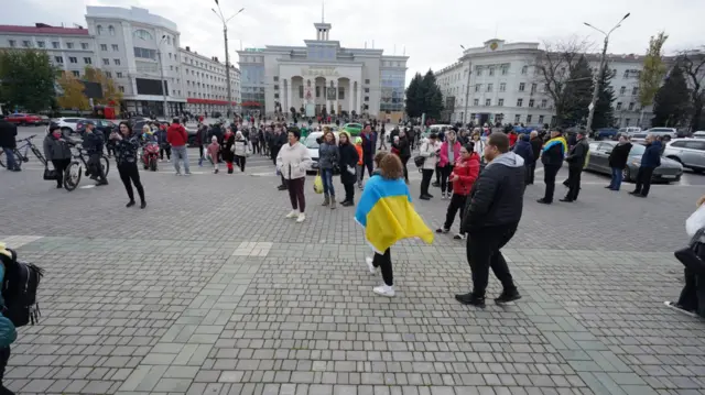 People gathering in central Kherson yesterday after Russian forces withdrew from the city