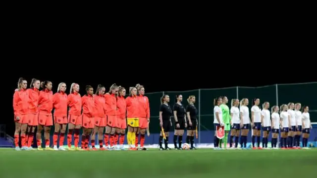 Players line up on the pitch