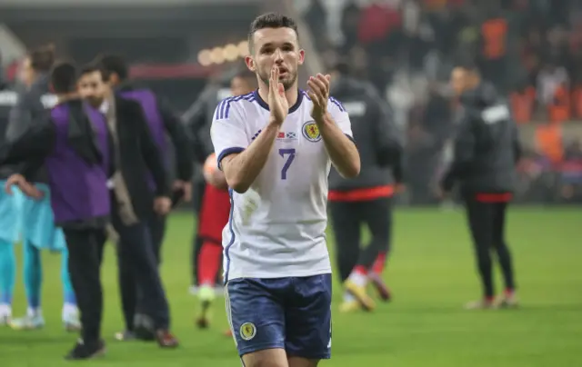 John McGinn applauds the small band of travelling fans