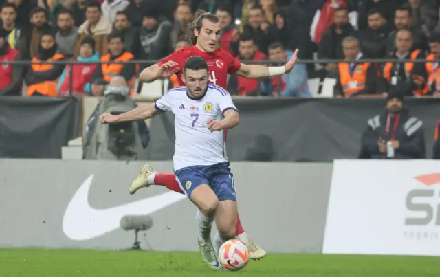 John McGinn drives forward to score for Scotland