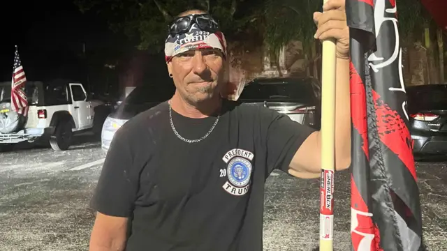 Derek Arnold holding a flag