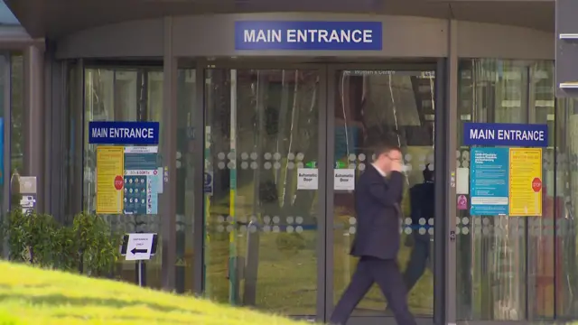 A man walks past the entrance to the South West Acute Hospital in Eniskillen