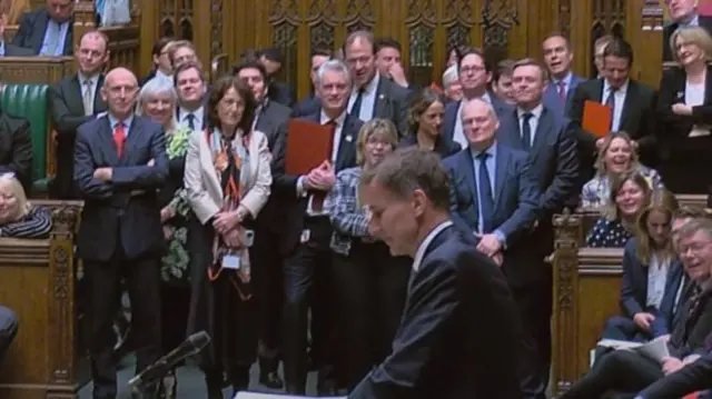 A packed Commons chamber watches the chancellor