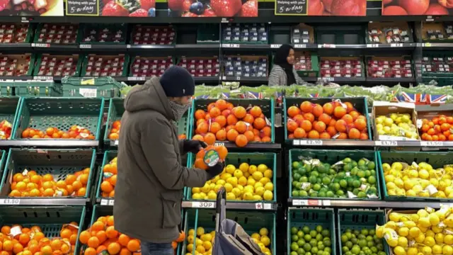 A customer shops for food items inside a Tesco supermarket store in east London on January 10, 2022.