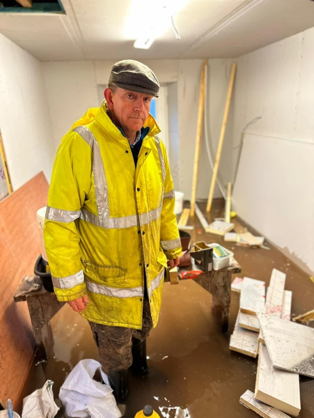 Christopher Maguire in flooded property