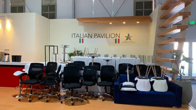 Image shows a dozen empty chairs in a room called Italian Pavilion