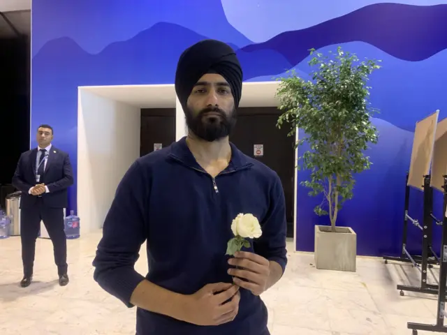 Portrait of Amit Singh holding white rose