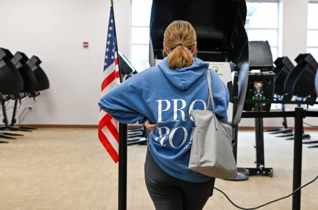 A resident wearing a Pro Roe sweatshirt casts their ballots for the 2022 midterm election in Columbus, Ohio