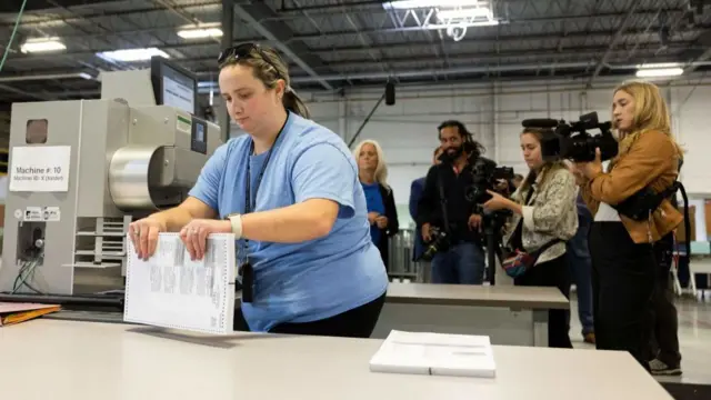 A Pennsylvania election worker demonstrates how votes are counted