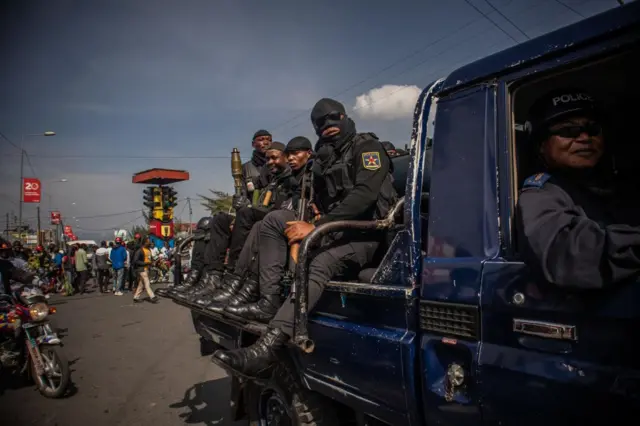 Democratic Republic of Congo Police officers drive on a pick up truck as anti-Rwanda protesters make their way to the border of the Democratic Republic of Congo and Rwanda in Goma, on October 31, 2022