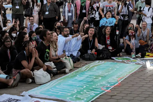 Climate activists chant slogans during a demonstration demanding adherence to limit global temperature rise to 1.5 degrees Celsius compared to pre-industrial levels, during the COP27 climate conference in Egypt's Red Sea resort city of Sharm el-Sheikh on 18 November 2022.