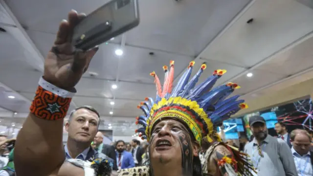 A climate activist is seen with traditional clothes as Brazilian President Luiz Inacio Lula da Silva (not seen) attends the Panel on Brazil and the Amazon Jungle before attending the 2022 United Nations Climate Change Conference (COP27) in Sharm El Sheikh, Egypt on 16 November 2022.