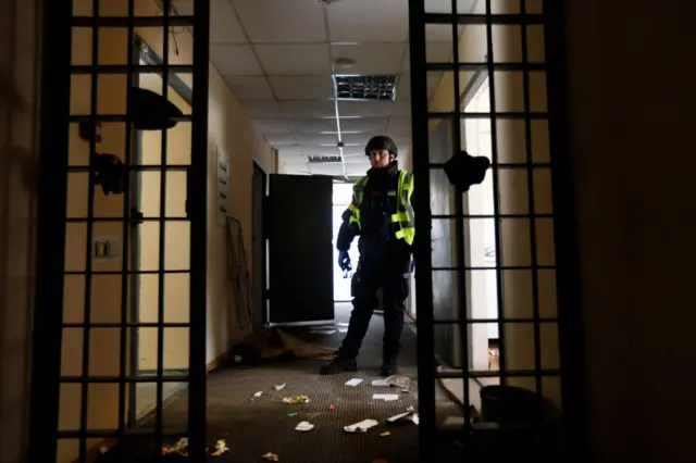 A Ukrainian police officer stands inside a detention centre in Kherson