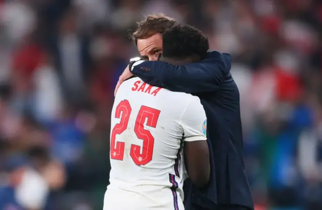 Bukayo Saka hugged by Gareth Southgate