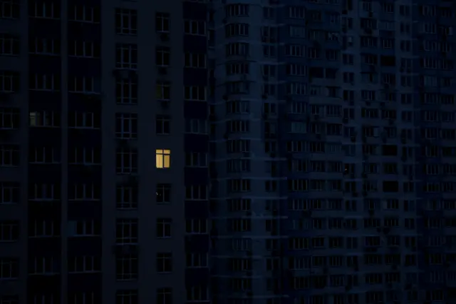 Image shows a tower block with just one light on