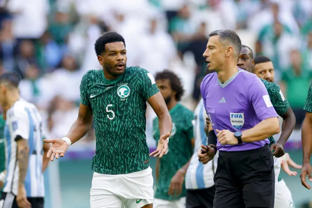 Saudi Arabia players protest with the referee