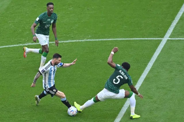 Argentina's forward #10 Lionel Messi fights for the ball with Saudi Arabia's defender #05 Ali Al-Bulaihi during the Qatar 2022 World Cup Group C football match between Argentina and Saudi Arabia