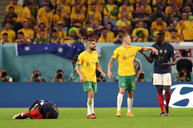 Ousmane Dembele on the floor in pain while Mitchell Duke is grabbed by Ibrahima Konate