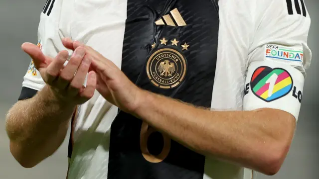 A close-up of a Germany player wearing the OneLove anti-discrimination armband