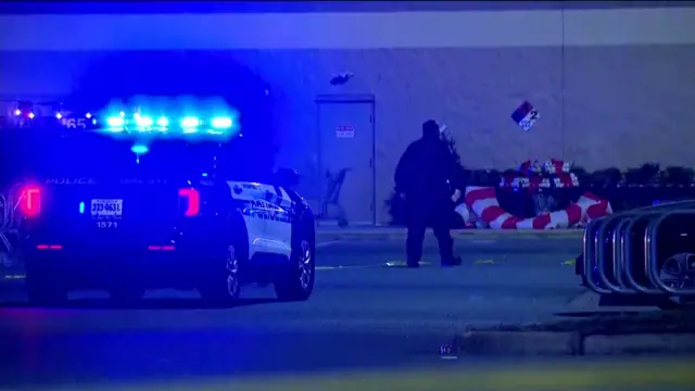 police officer walks outside the Walmart store