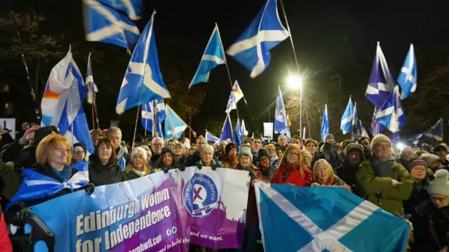 People attend a rally outside the Scottish Parliament in Edinburgh