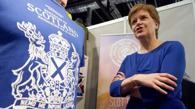 First Minister Nicola Sturgeon pictured next to a "Scottish passport" t-shirt at an SNP conference in Aberdeen