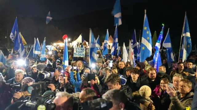 People attend a rally outside the Scottish Parliament in Edinburgh