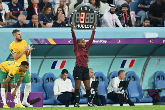 Rwandan referee Salima Mukansanga holds the substitute board during the FIFA World Cup 2022 Group D match between France and Australia at Al Janoub Stadium in Al Wakrah, Qatar