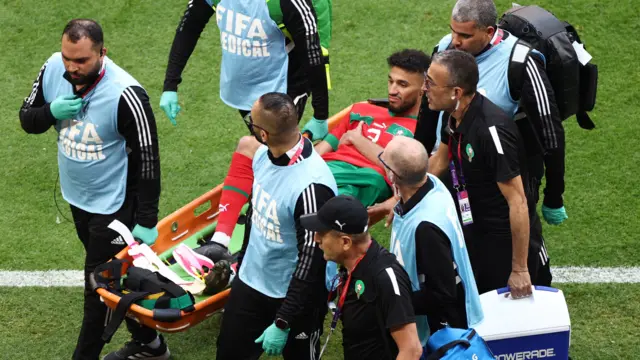 Noussair Mazraoui is taken off on a stretcher