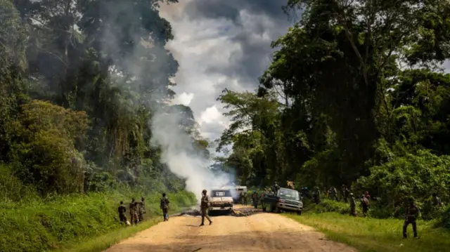 Congolese Army Soldiers and UN troops inspect an ambush site where an hour previously ADF fundamentalist rebels attacked two vehicles on the road between Beni and the Ugandan border town of Kasindi, on April 9, 2021 in Kilya,