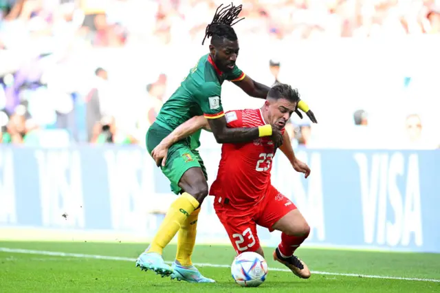 Xherdan Shaqiri of Switzerland battles for possession with Andre-Frank Zambo Anguissa of Cameroon