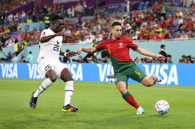 Portugal's' Raphael Guerreiro takes on Alidu Seidu