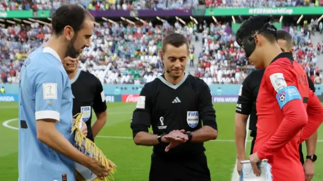 Captains Diego Godin of Uruguay and Heungmin Son of Korea Republic attend the coin toss prior to the FIFA World Cup Qatar 2022 Group H match between Uruguay and Korea Republic at Education City Stadium