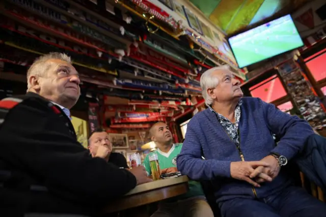 People watch the FIFA World Cup match Germany v Japan at a pub in Cologne, Germany, November 23