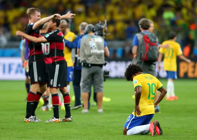 Willian on his knees as Germany celebrate in 2014