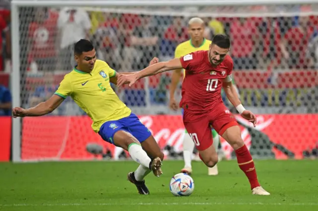 Dusan Tadic is challenged by Casemiro