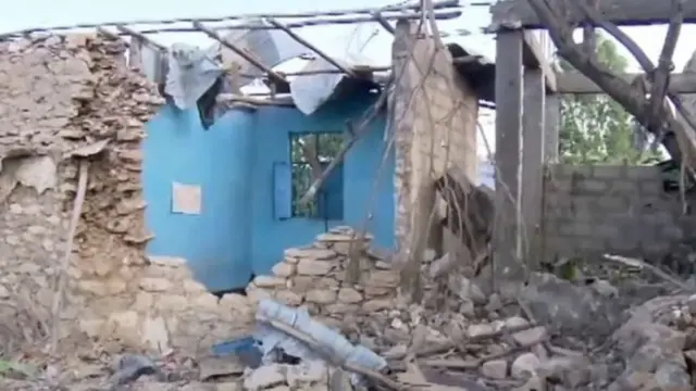 Screen grab of video showing destroyed houses