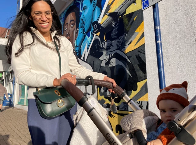 Chanelle Marcella-Wint with her son Luca in front of the mural