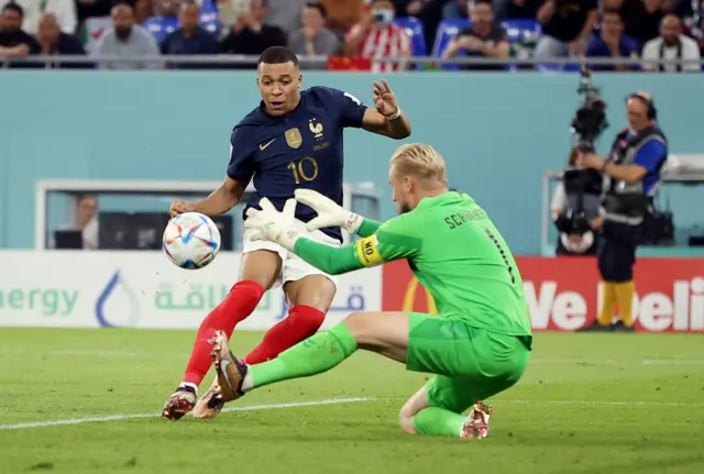 Denmark's Kasper Schmeichel in action with France's Kylian Mbappe