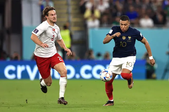 Kylian Mbappe of France controls the ball against Joachim Andersen of Denmark during the FIFA World Cup Qatar 2022 Group D match between France and Denmark at Stadium 974