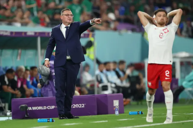 Poland boss Czeslaw Michniewicz directs his players as Matty Cash prepares to take a throw-in