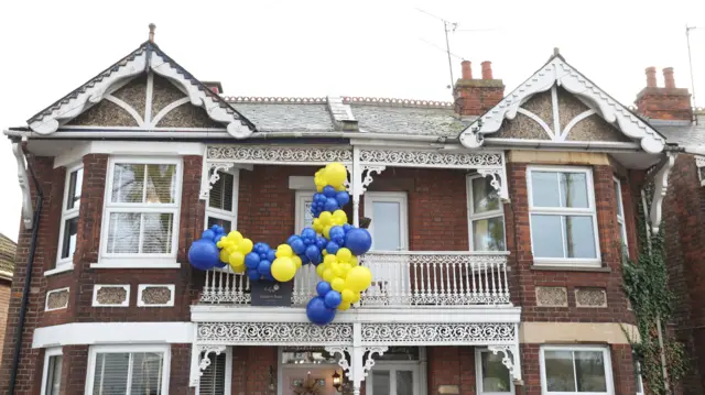 Balloons outside a house outside King's Lynn's stadium