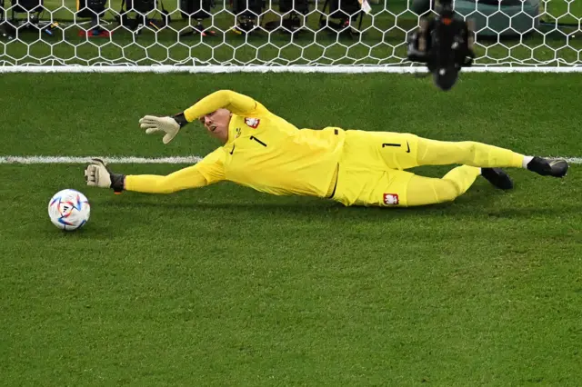 Poland's goalkeeper Wojciech Szczesny stops a penalty by Saudi Arabia's midfielder #10 Salem Al-Dawsari during the Qatar 2022 World Cup Group C football match between Poland and Saudi Arabia at the Education City Stadium in Al-Rayyan, west of Doha on November 26, 2022