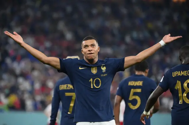 Kylian Mbappe celebrates opening the scoring against Denmark