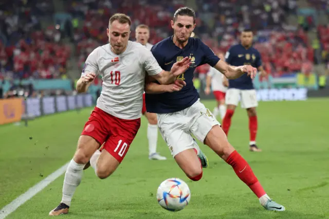 Denmark's midfielder #10 Christian Eriksen fights for the ball with France's midfielder #14 Adrien Rabiot during the Qatar 2022 World Cup Group D football match between France and Denmark at Stadium 974 in Doha